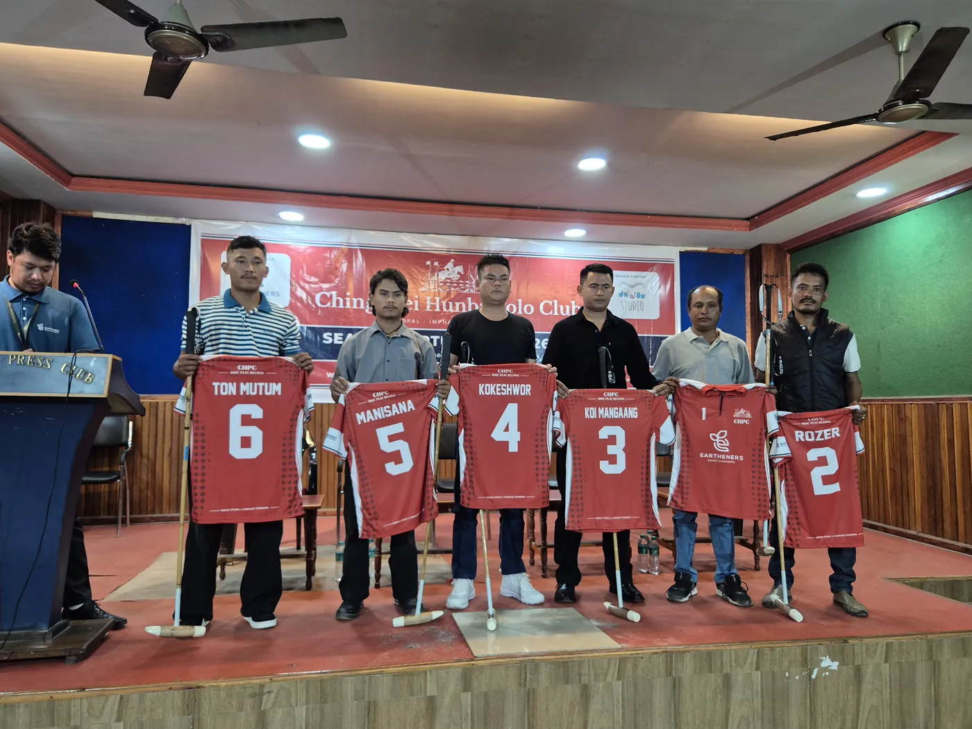 The six Chingkhei Hunba Polo Club players on stage at the Manipur Press Club, holding up their new jerseys, each with a new polo mallet